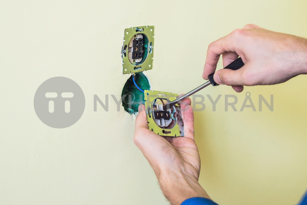 Electrician Installing Socket In New House