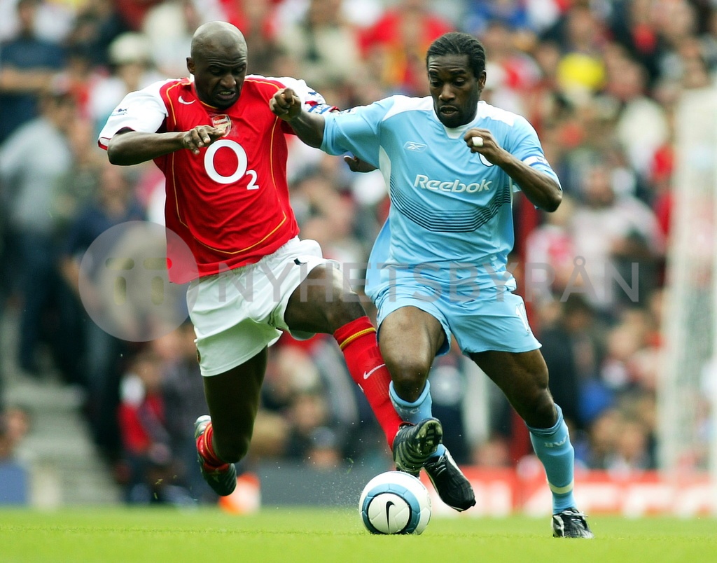 Arsenal S Patrick Vieira Tries To Catch Bolton Wanderers Jay Jay Okocha In The English Premier League At Highbury