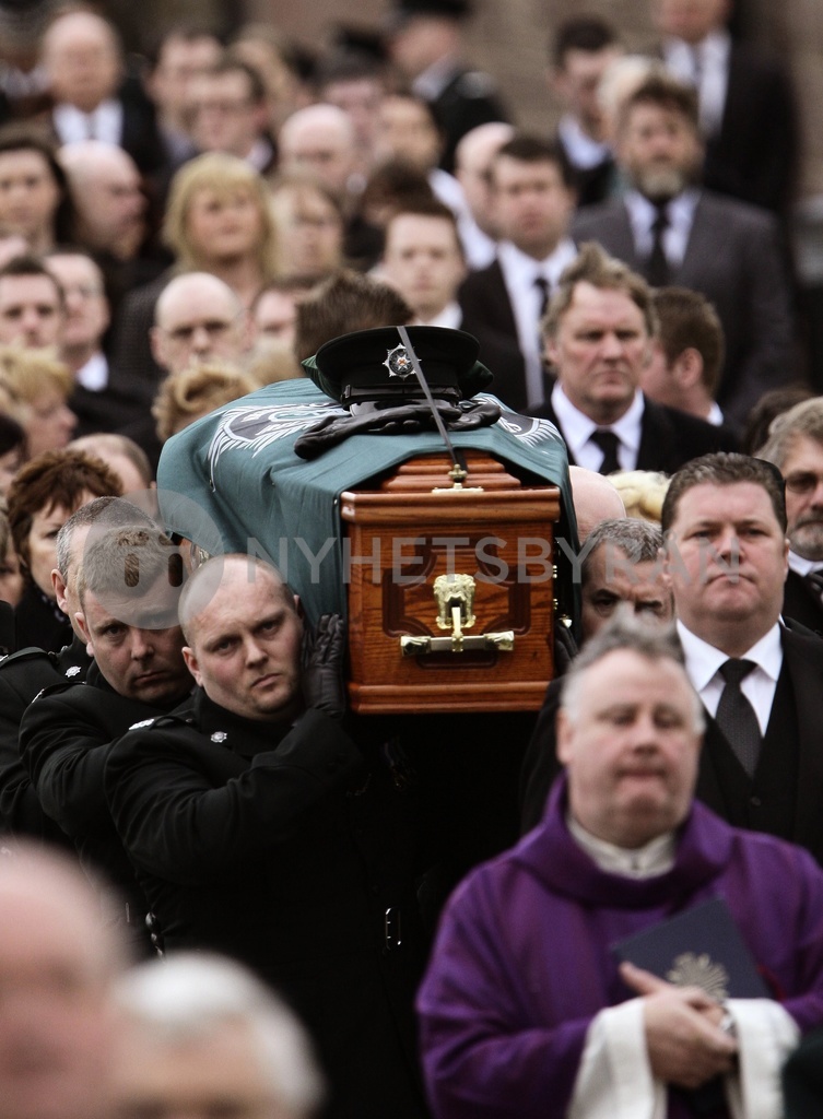 Northern Ireland police officers carry the coffin of Constable Stephen ...