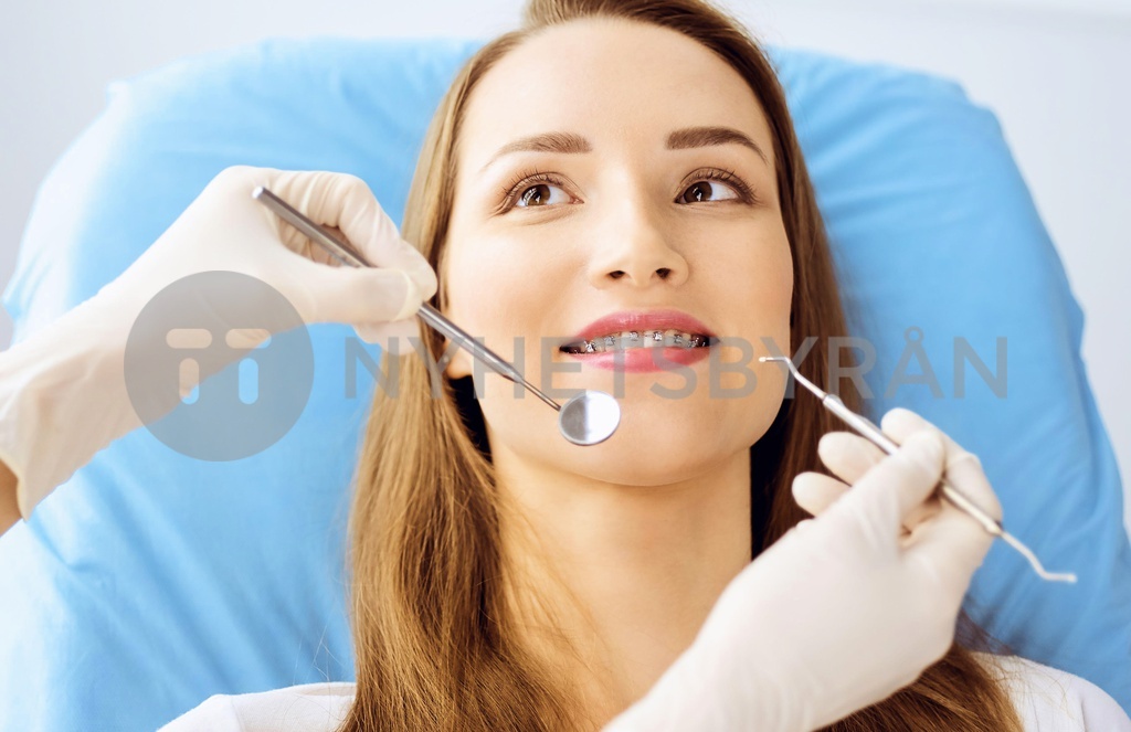 Smiling Young Woman With Orthodontic Brackets Examined By Dentist At ...