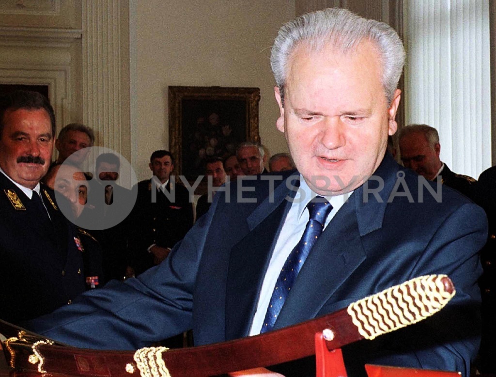 YUGOSLAV PRESIDENT SLOBODAN MILOSEVIC LOOKS AT A PARADE SABRE HE